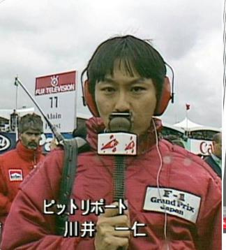 川井一仁、レポーター、赤い服を着てマイクを持ってレポートをしている